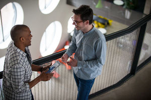 Colleagues talking in a corridor