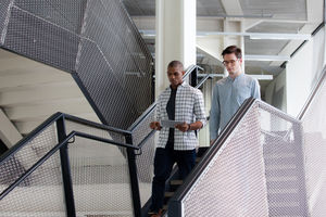 Colleagues talking on a staircase