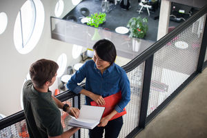 Colleagues talking in a corridor