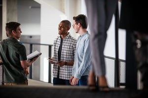 Colleagues talking in a corridor