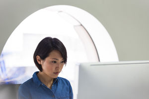 Asian businesswoman working on a desktop computer
