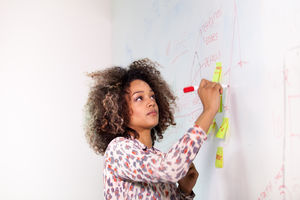 Student writing on white board 