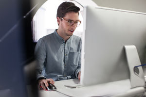 Businessman using mouse on computer