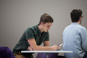 Man using smartphone in waiting area