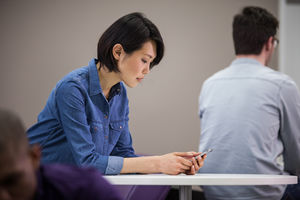 Woman using smartphone in waiting area