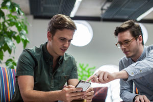 Colleagues in a meeting using smartphone