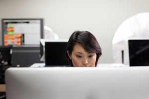 Asian businesswoman working on a desktop computer