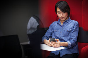 Businesswoman in a pod using smartphone