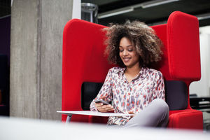 Businesswoman in a pod using smartphone