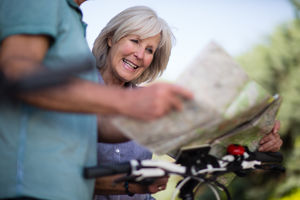 Senior couple looking at map on cycling vacation