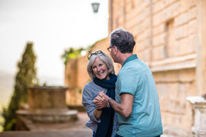 Senior couple dancing in the street on vacation