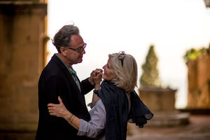 Senior couple dancing in the street on vacation