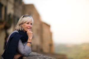 Senior woman on vacation looking at a tourist site