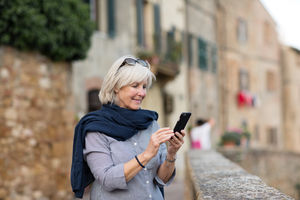 Senior woman on vacation using a smartphone
