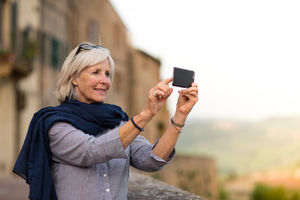 Senior woman on vacation taking a photo