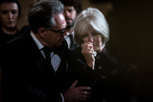 Senior woman being comforted at a funeral