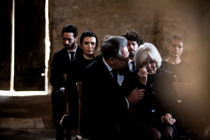 Senior woman being comforted at a funeral