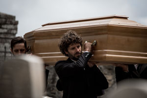 Pallbearers lifting a coffin