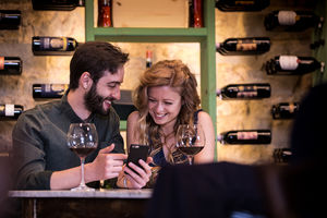 Young couple looking at a smartphone on a date
