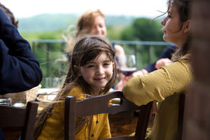Portrait of girl at a family meal outdoors