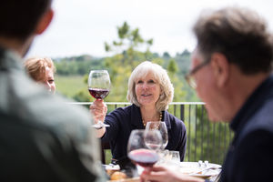 Senior woman raising a glass of wine