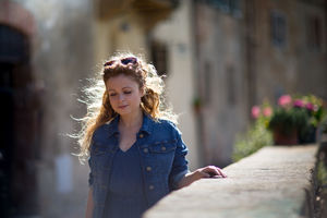 Young adult walking in Tuscan village