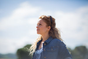 Young adult female looking at blue sky
