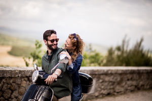 Young couple on motorbike together about to ride off