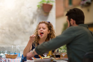 Young couple eating alfresco on vacation