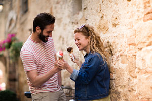 Young female eating gelato with boyfriend