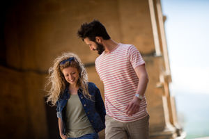 Young couple walking down street on vacation