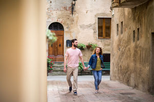 Young couple walking down street on vacation