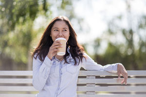 Woman sitting on bench in park