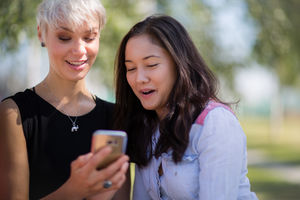 Female friends looking at smartphone