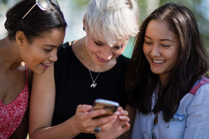 Female friends looking at smartphone