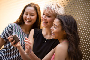 Female friends looking at smartphone