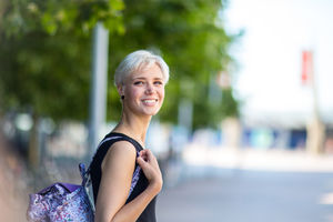 Young adult walking down street in a city