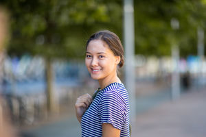 Young adult walking down street in a city