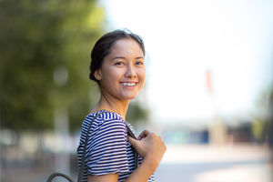 Young adult walking down street in a city