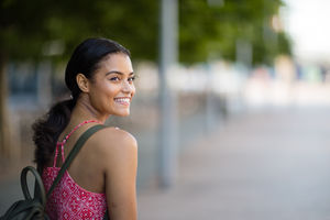 Young adult walking down street in a city