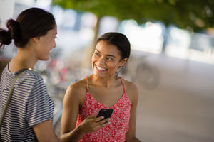Students on way to college looking at smartphone