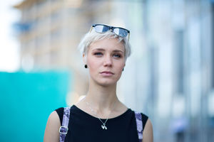 Young adult walking down street in a city