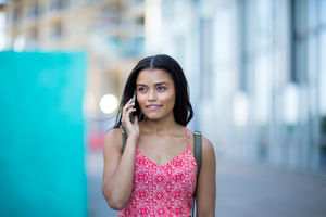 Young adult commuting and using smartphone