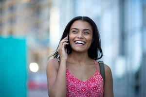 Young adult commuting and using smartphone