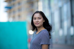 Young adult walking down street in a city