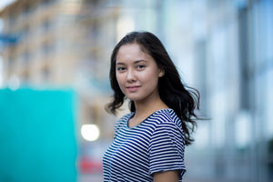 Young adult walking down street in a city