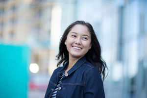 Young adult walking down street in a city