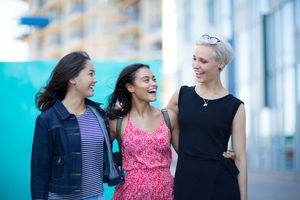 Young adults walking down a street together