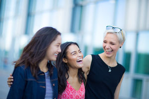 Young adults walking down a street together