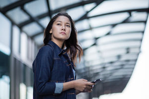 Young adult waiting on station platform